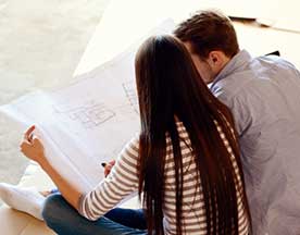 couple looking at blueprint